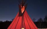 The tipi tent at night when the fire is going. 